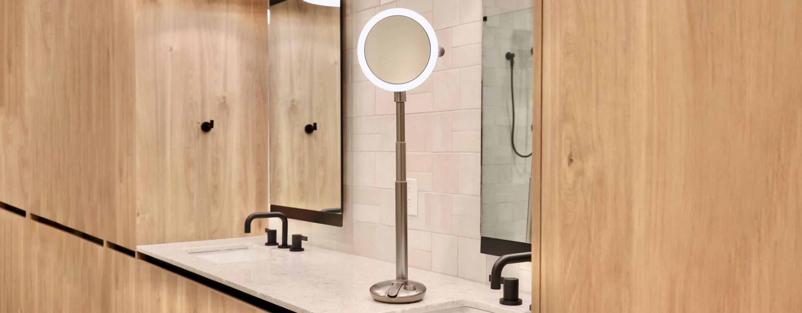 The Mirror Glow Mirror on a bathroom counter.