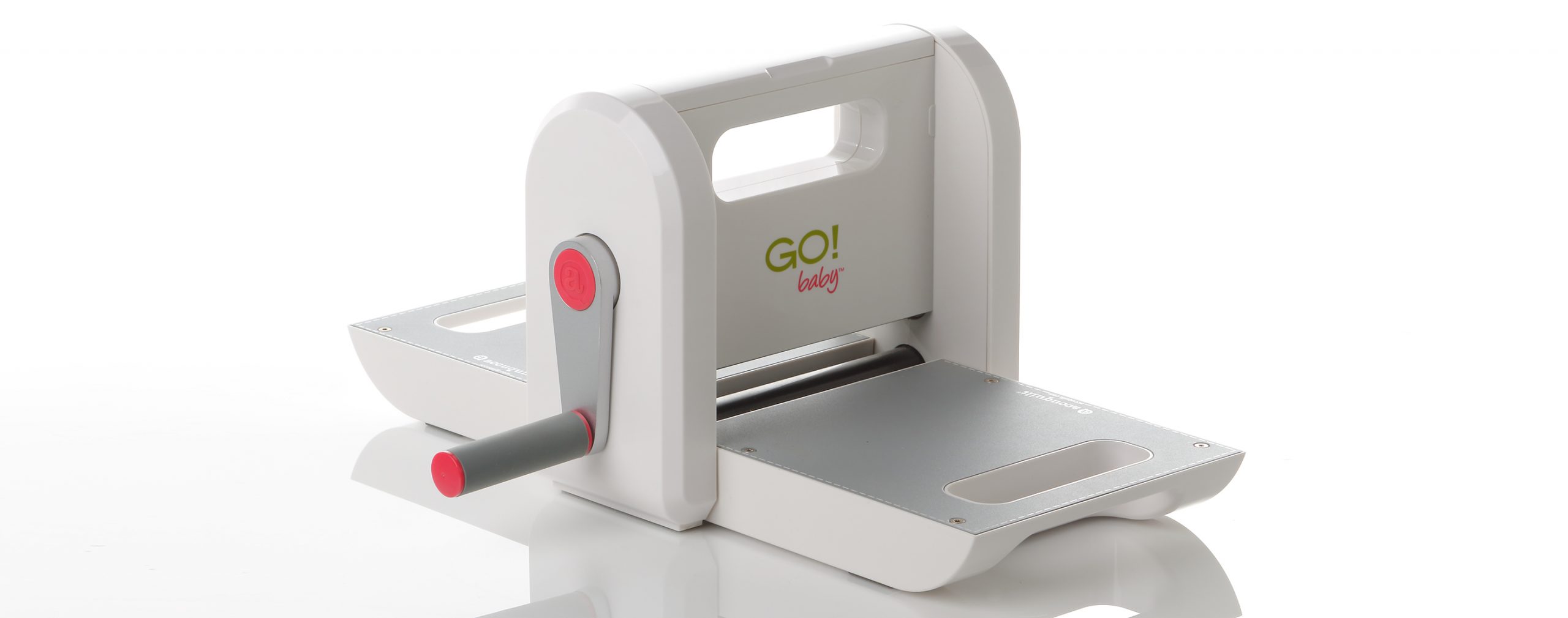 The AccuQuilt Go! baby, a small die cutting fabric cutter, with the cutting tray open.