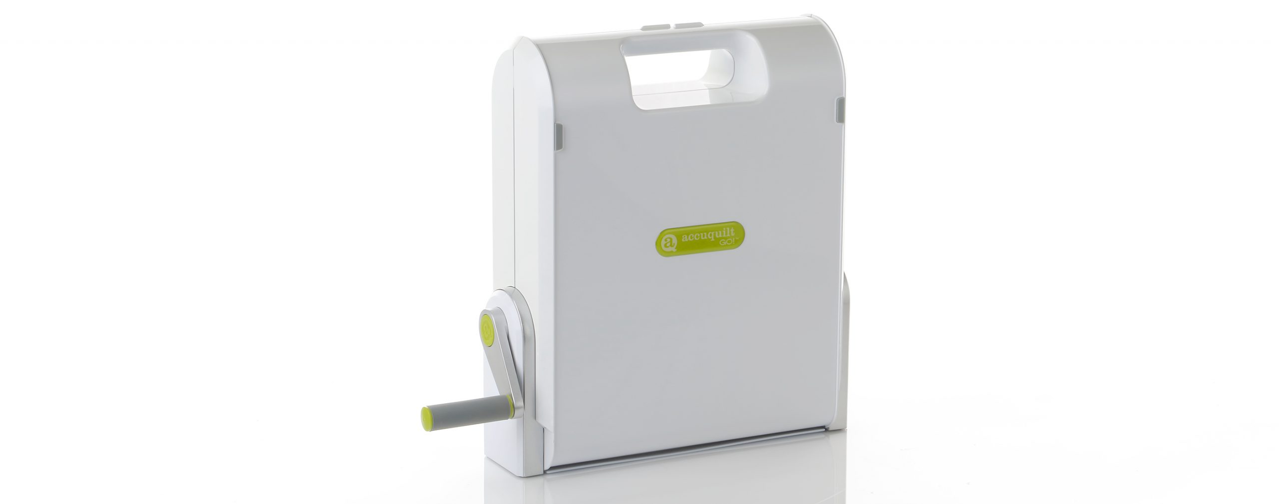 The AccuQuilt Go!, closed and standing upright. The hand crank is point to the left.