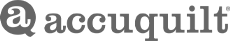 The AccuQuilt logo in gray. An A in a speech bobble with, "accuquilt" next to it.