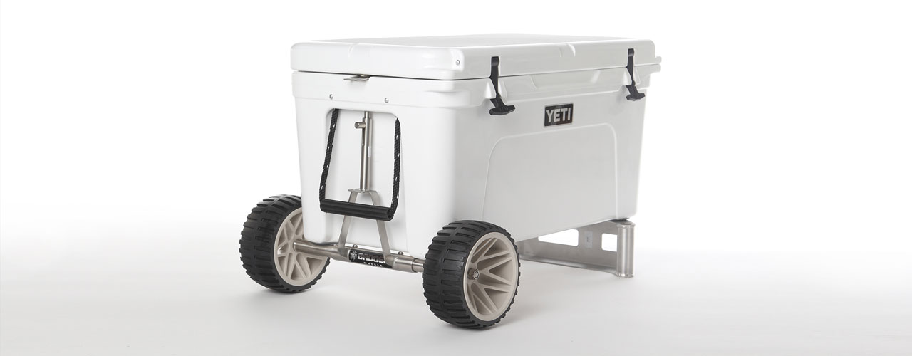The Cooler Extra's Badger line of cooler wheel add ons, added to a Yeti cooler and the back of the cooler is resting on the metal handle.