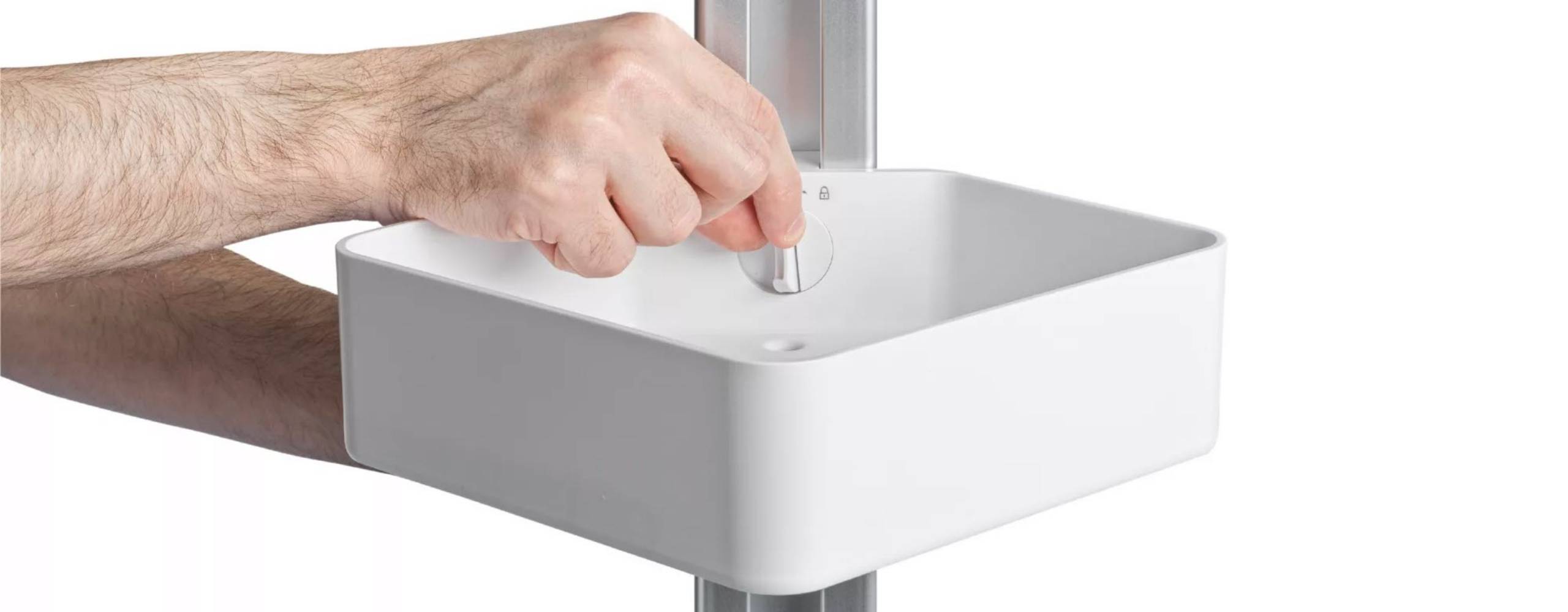 Two hands are on the Sharper Image Shower Caddy. The back hand is holding up the pole, while the front hand is pinching the locking knob.