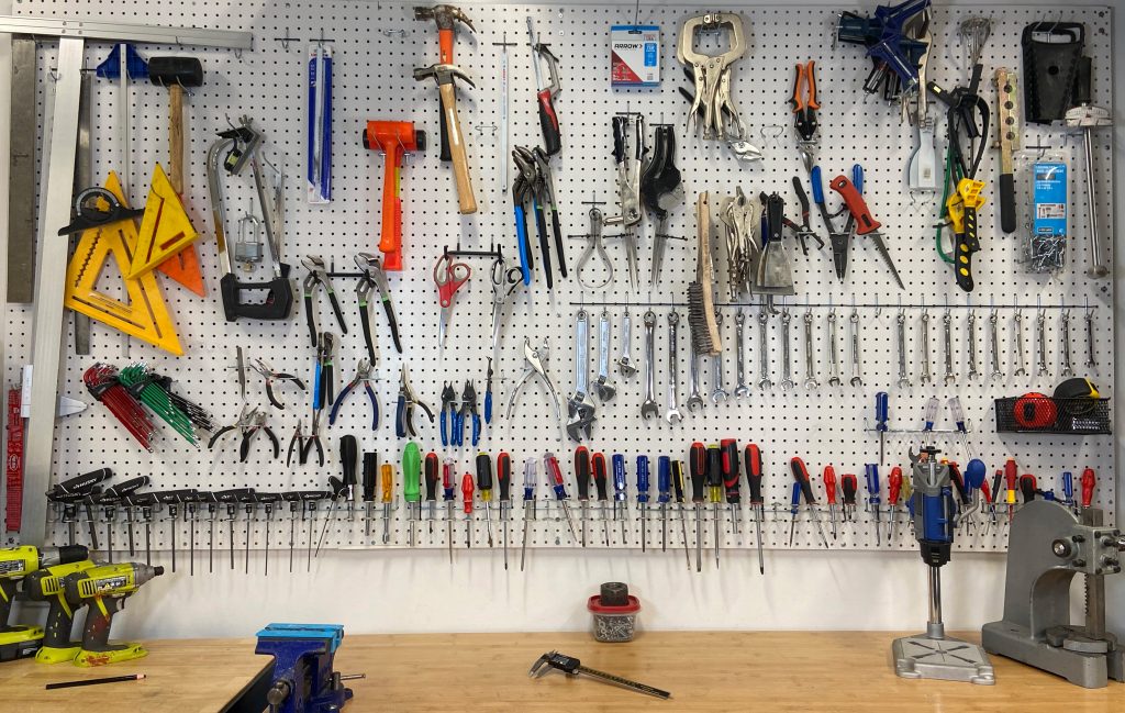 Pump Studios shop's peg board full of hand tools.