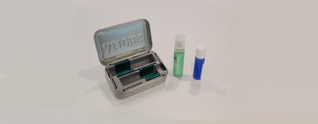 Peter's insert in an Altoids tin. Hand sanitizer spray and Chapstick next to it.