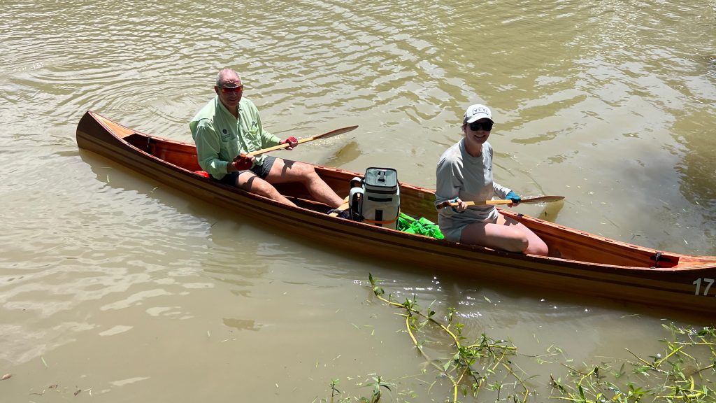 Liz Ruchte and her father in a canoe and the river.
